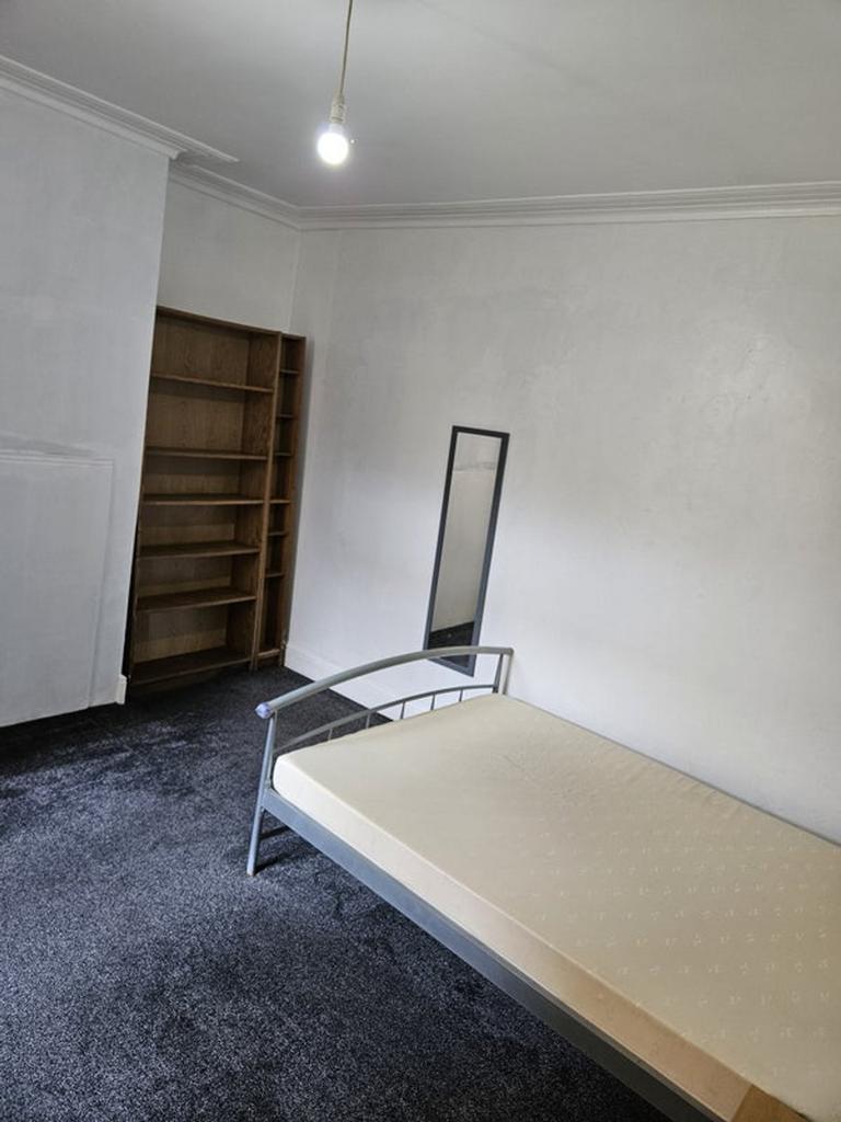 A spacious double bedroom featuring a large fit...