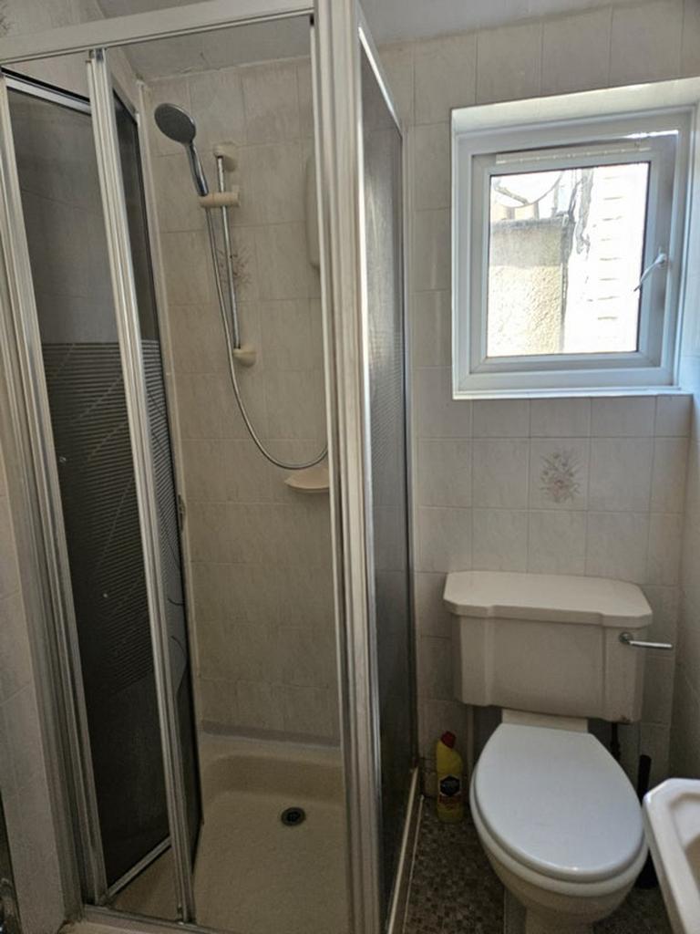 A modern bathroom featuring a sleek shower encl...