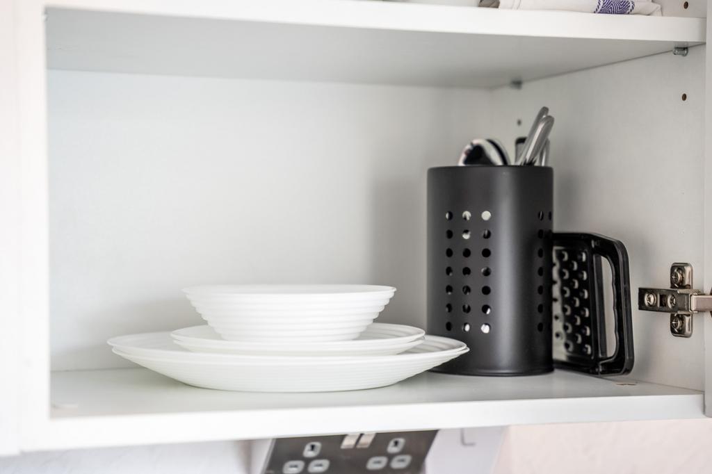 A well-organized kitchen shelf showcasing clean...