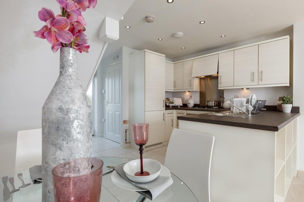 An open plan kitchen dining area is designed...