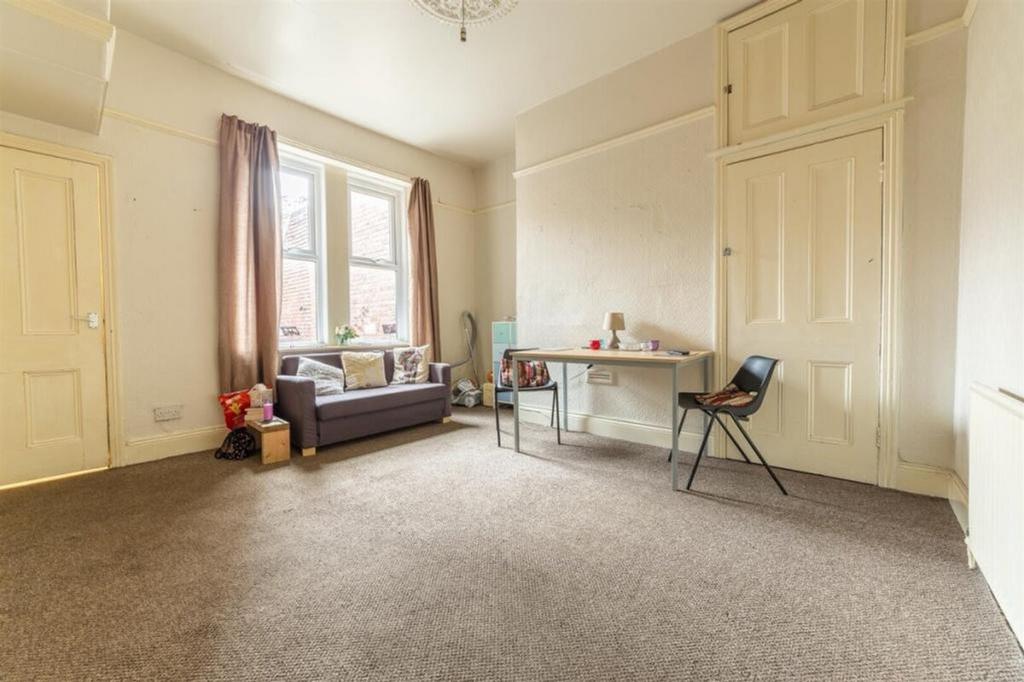 A spacious and well-lit living room, perfect fo...