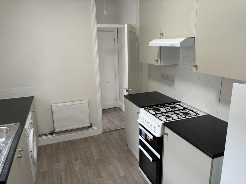 A tidy and functional kitchenette featuring ess...