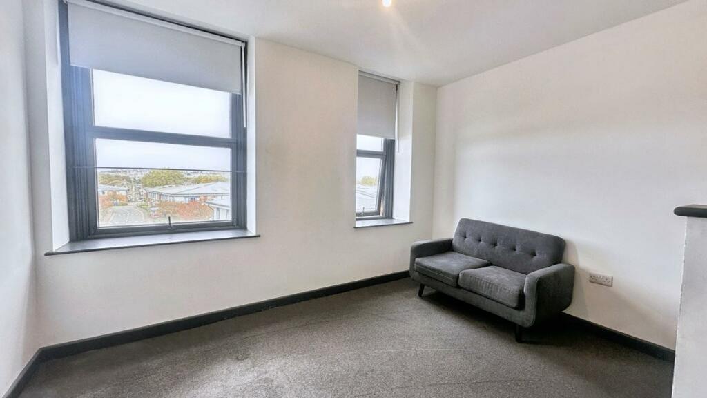 A bright and modern living room with large wind...
