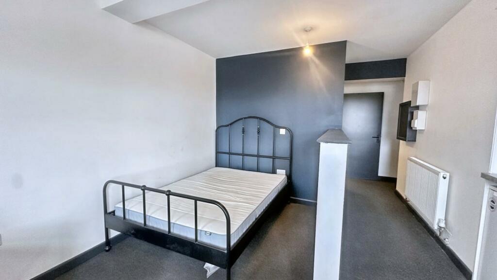 A spacious double bedroom with modern decor, pe...