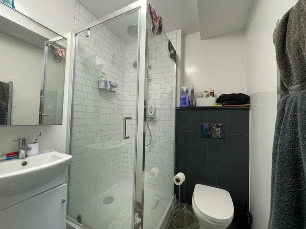 A bright and tidy bathroom featuring a modern s...