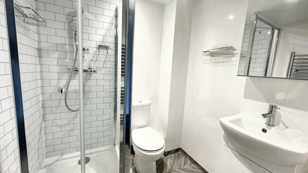 A modern and pristine bathroom featuring a styl...