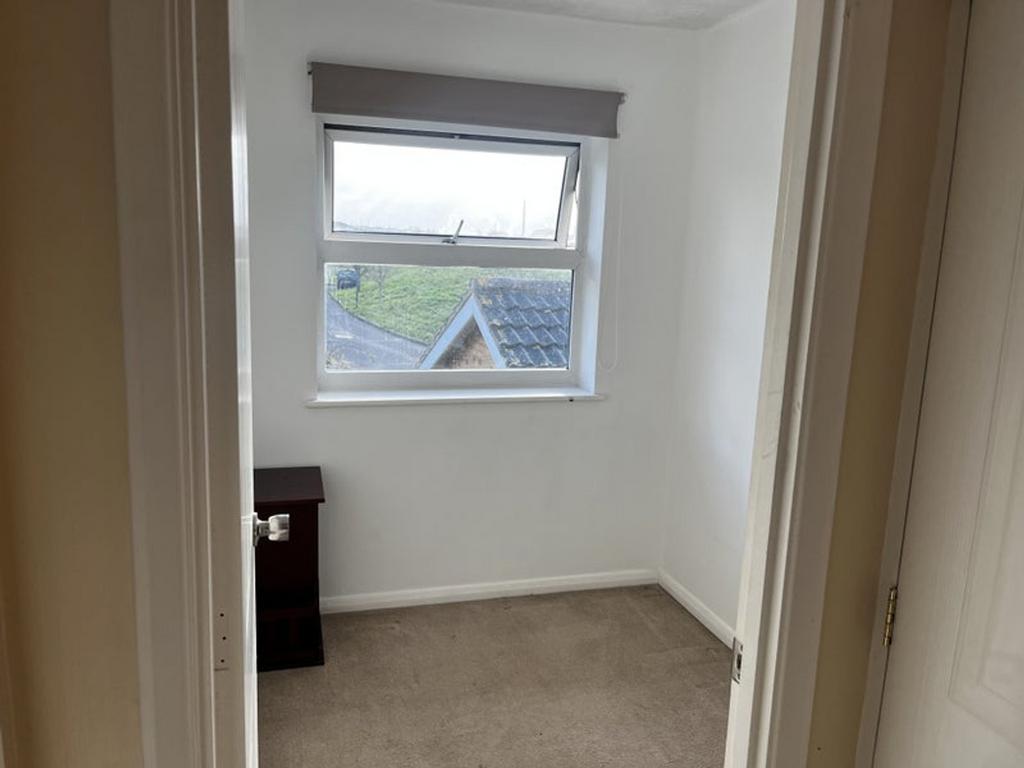 A cozy double bedroom featuring a window that i...