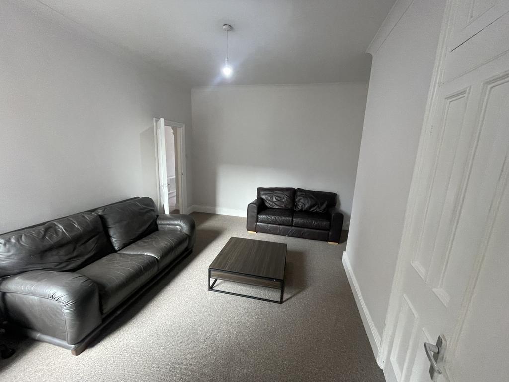 Bright neutral living room with two comfortable...