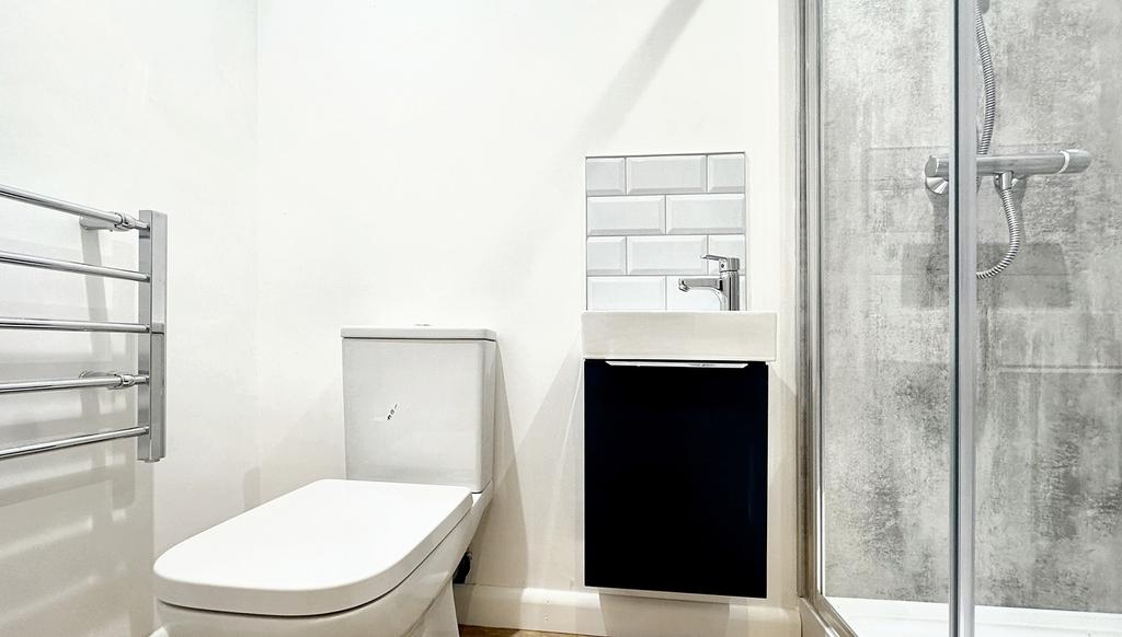 A modern bathroom featuring a sleek shower, sty...