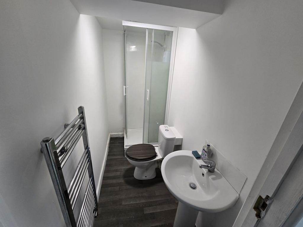 A modern bathroom featuring a sleek shower, sty...
