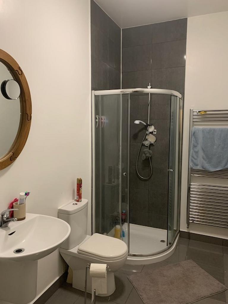 A modern bathroom featuring a sleek shower and ...
