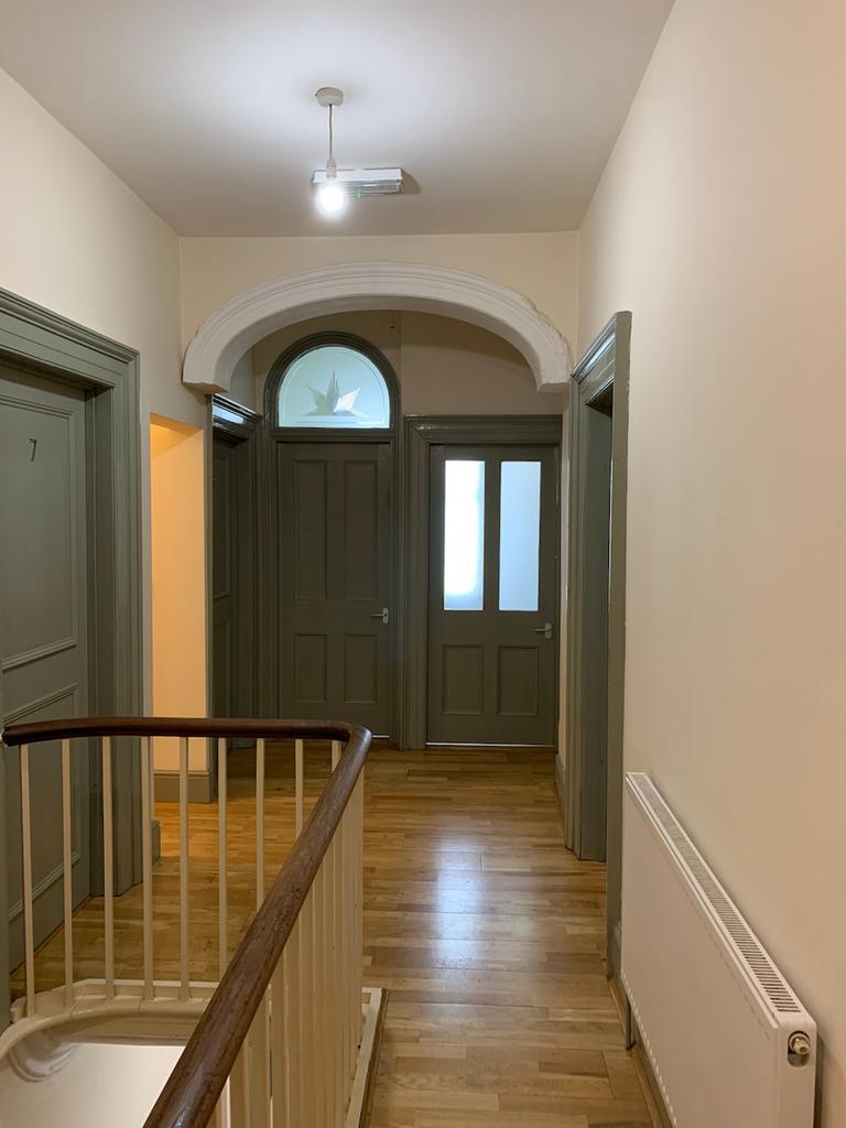 A well-maintained hallway with a bright and inv...