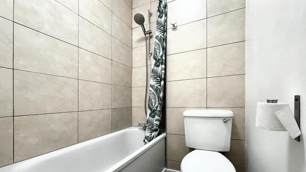 A modern bathroom featuring a clean design with...
