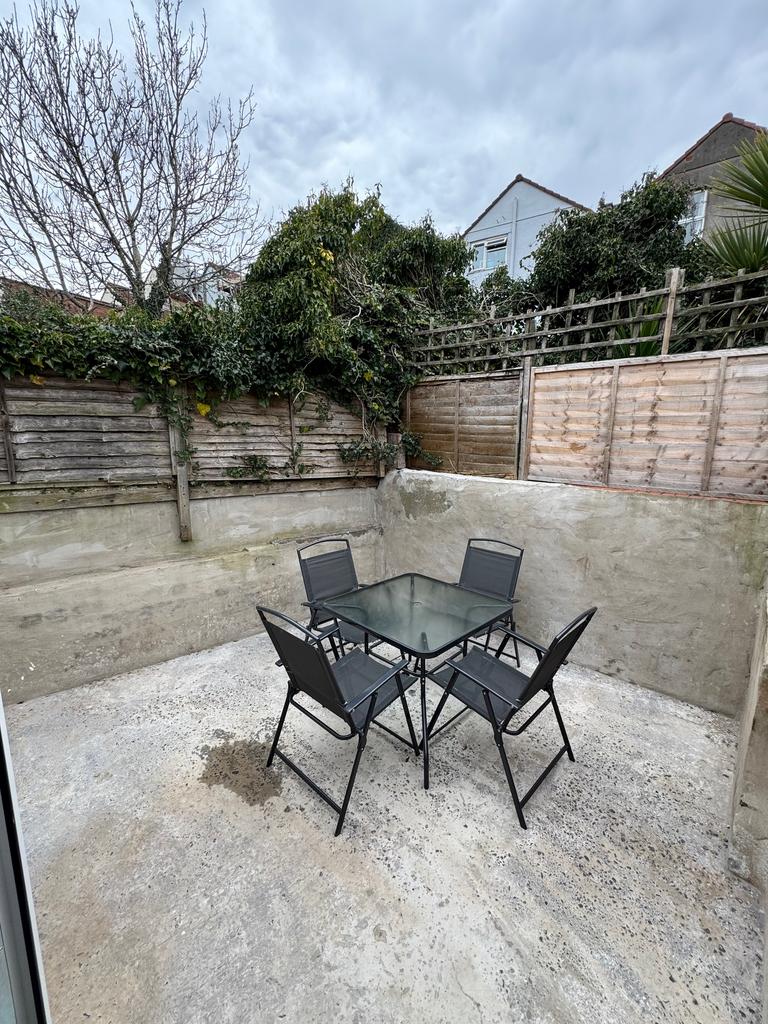 A charming garden space featuring a stylish tab...