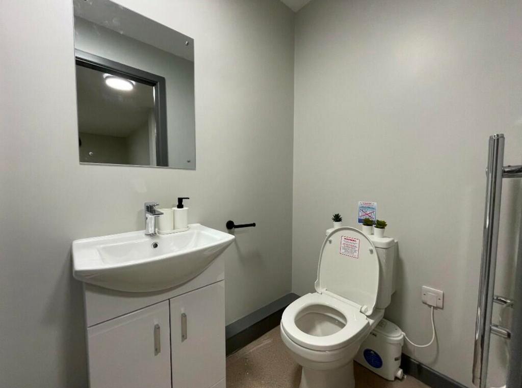 A clean and modern single toilet with stylish f...