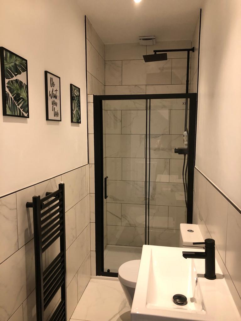 A modern and stylish bathroom featuring a spaci...