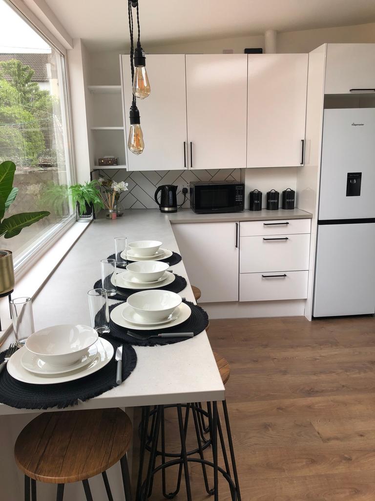 A modern and clean kitchenette with stylish dec...