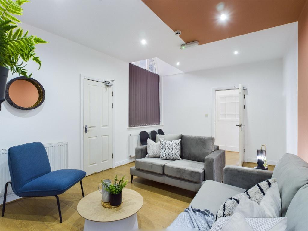 A welcoming and spacious living room with moder...