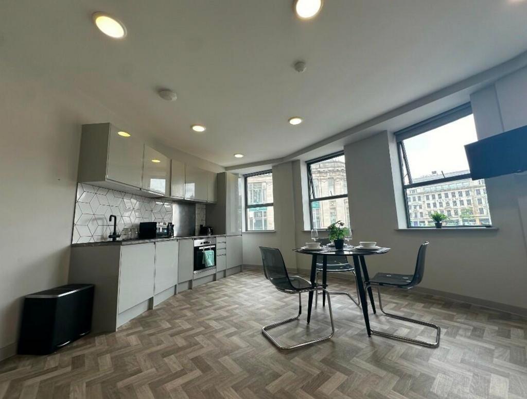 A bright and modern kitchenette with ample spac...
