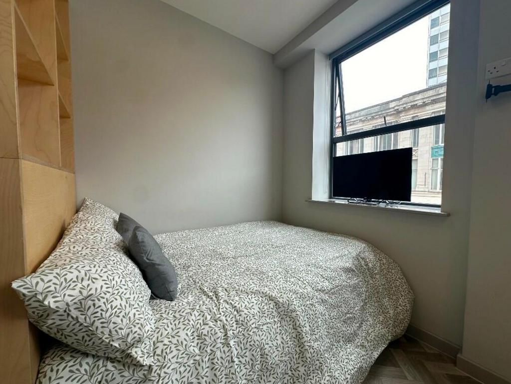 A stylish and inviting double bedroom with ampl...
