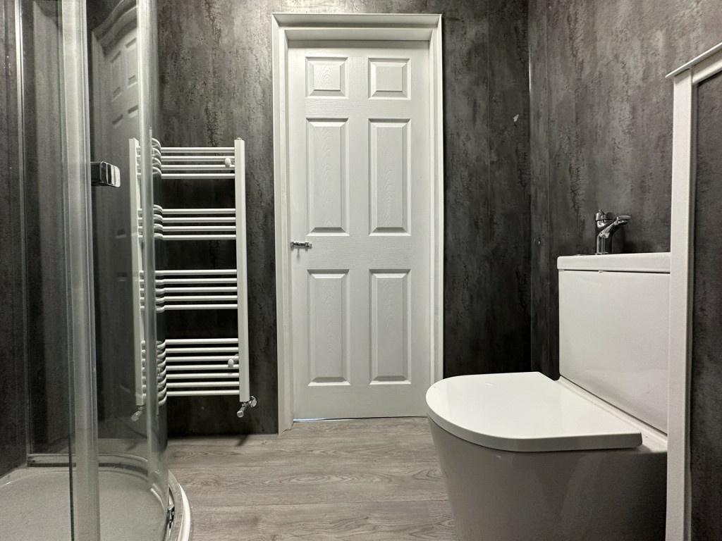 A modern, well-maintained bathroom with a clean...