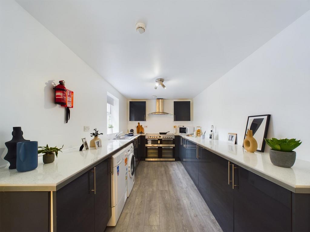 A spacious and modern kitchen with ample counte...