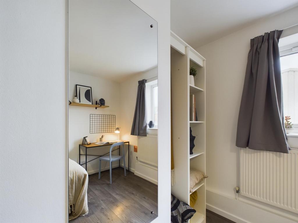 A stylish and well-organized double bedroom wit...
