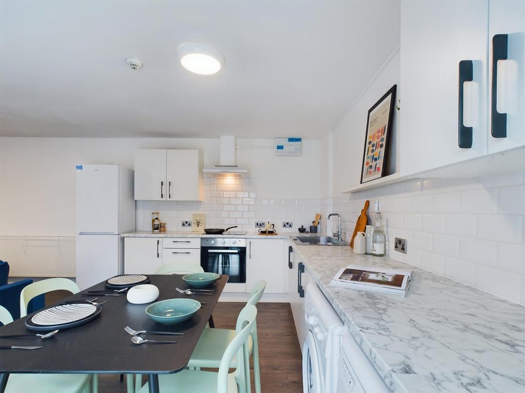 A modern and tidy kitchenette equipped with sty...