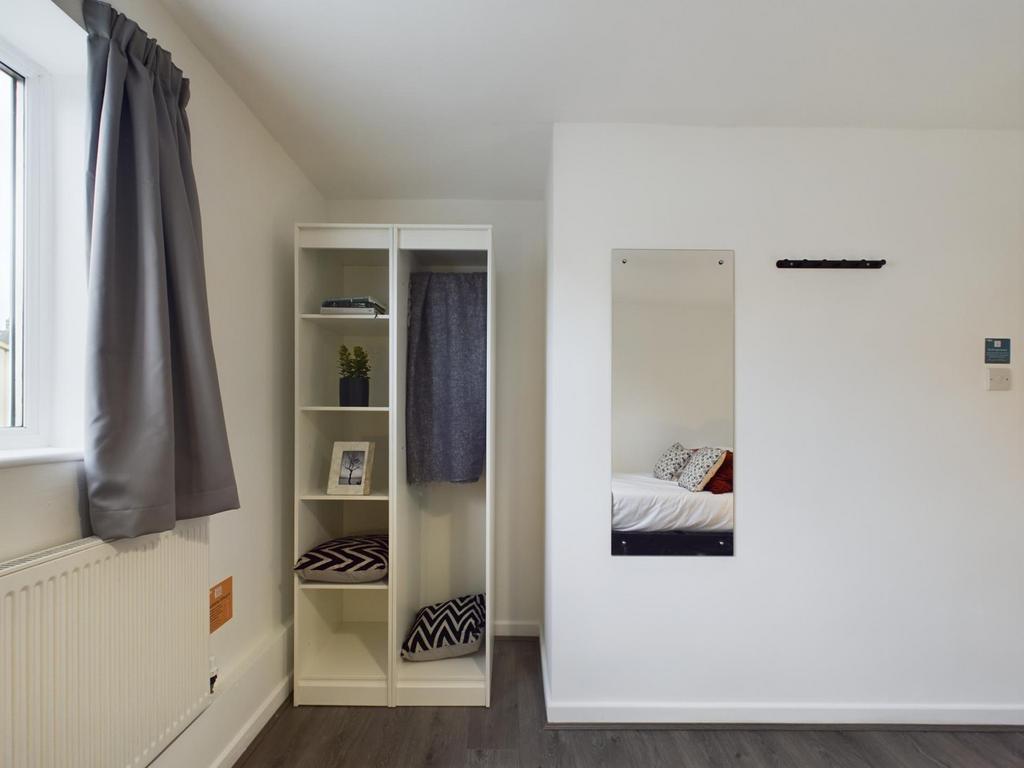 A bright and tidy double bedroom featuring a fi...
