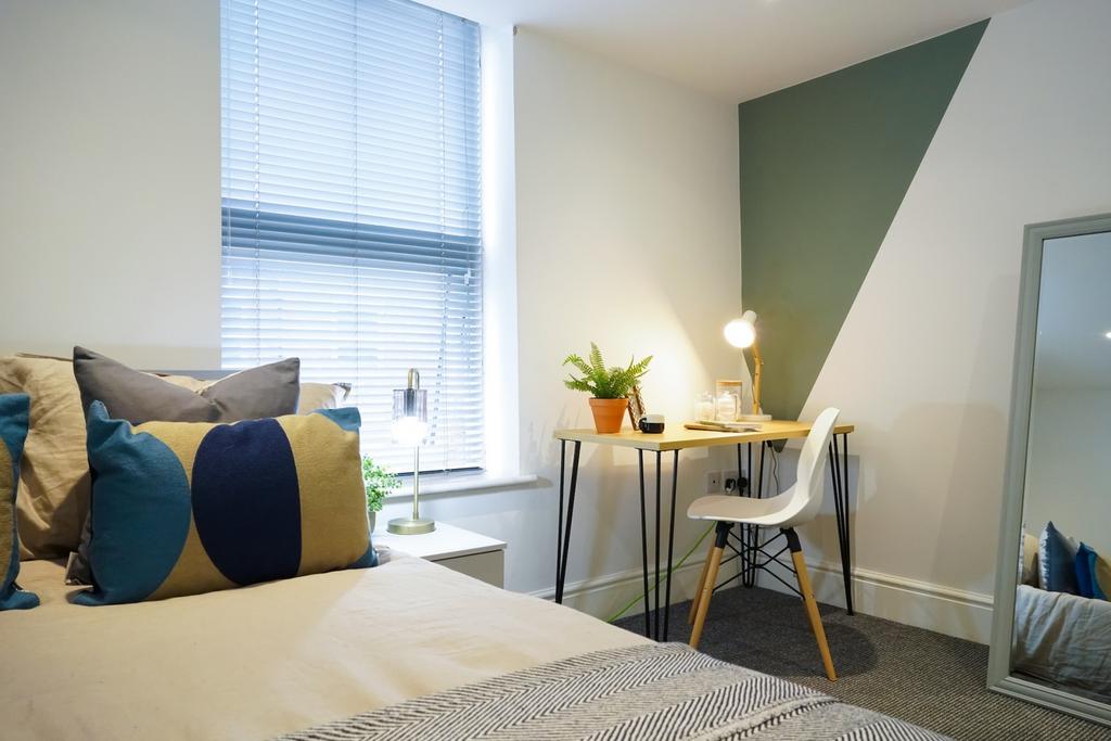 A bright and inviting double bedroom featuring ...