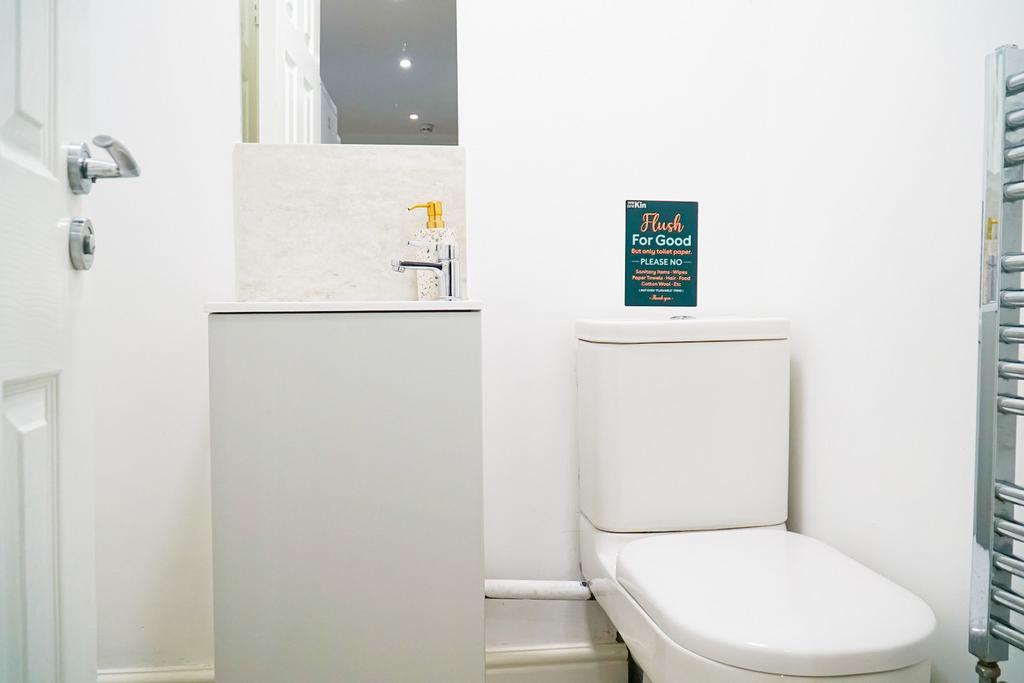 A bright and clean single toilet, equipped with...