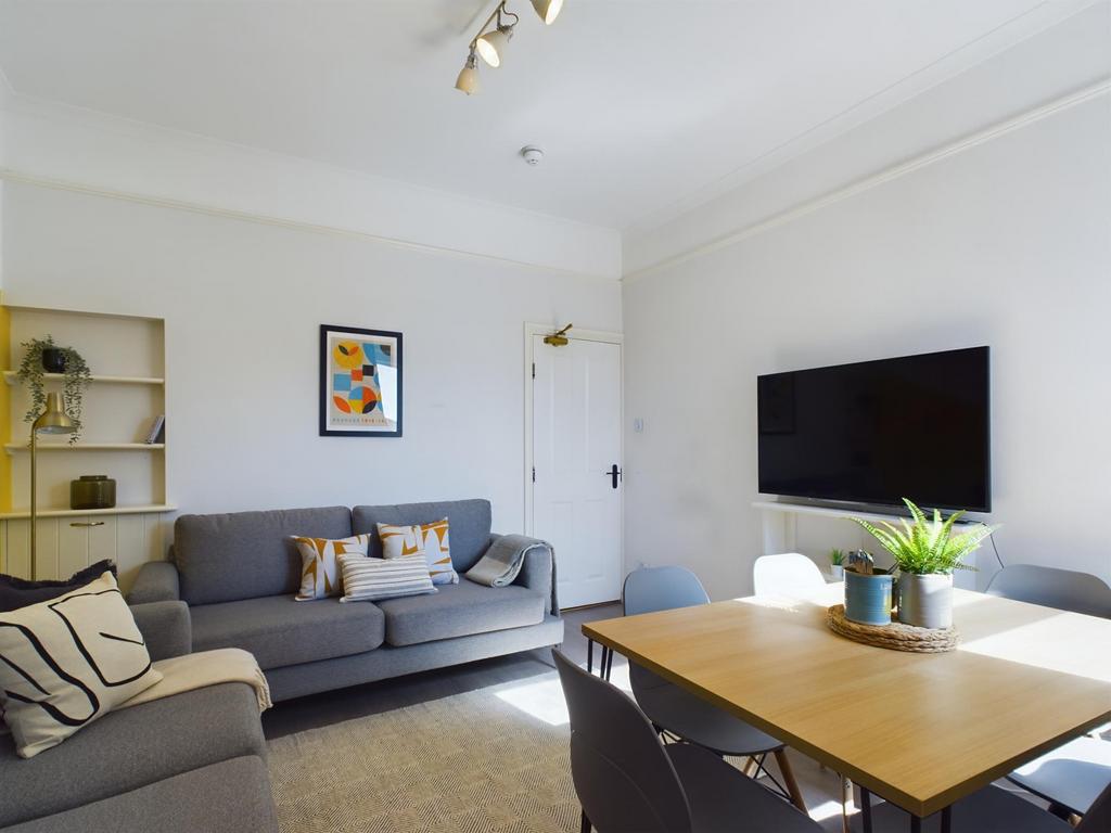 A modern, bright living room featuring a large ...