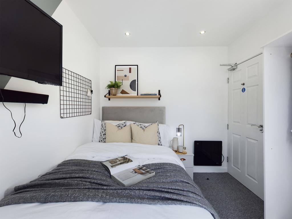 A bright and stylish double bedroom featuring m...