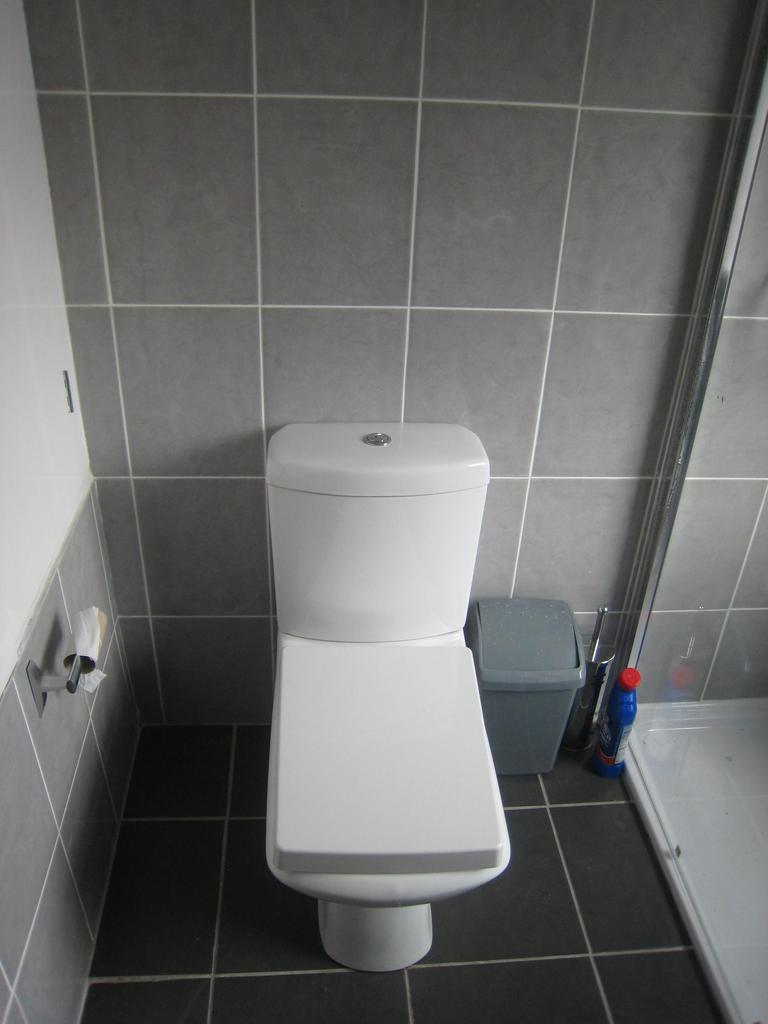 A modern and clean single toilet featuring slee...