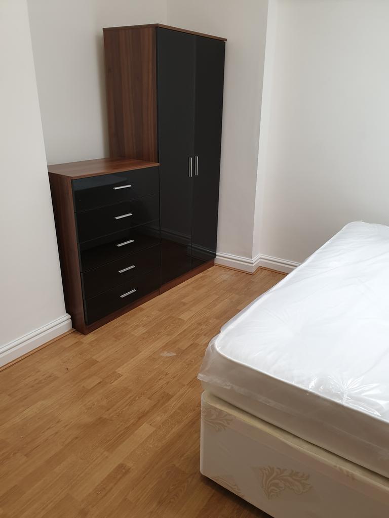 A bright and spacious double bedroom featuring ...