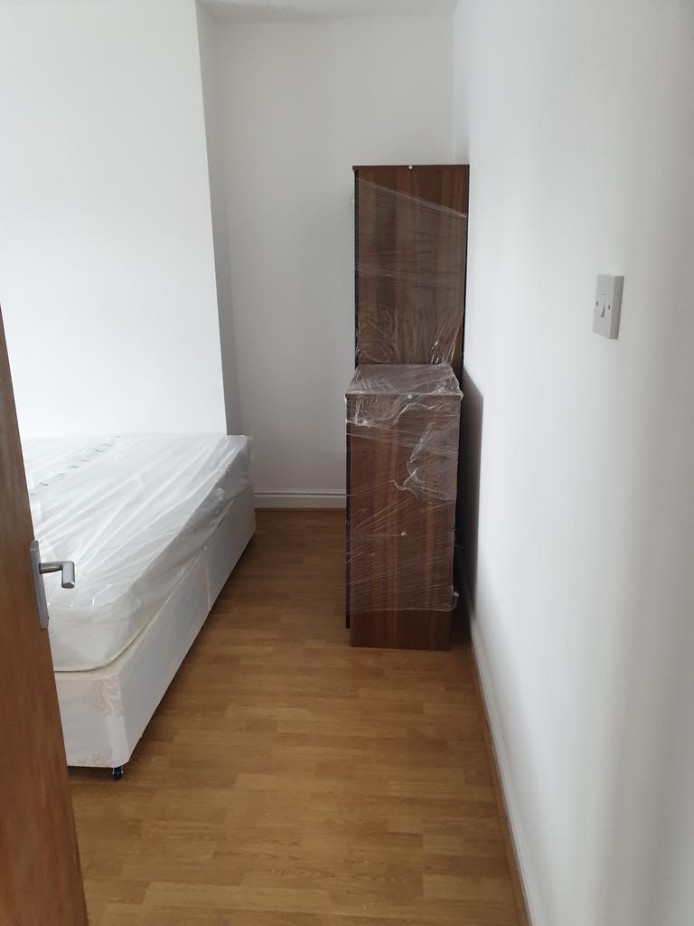 Discover a cozy double bedroom featuring a comf...