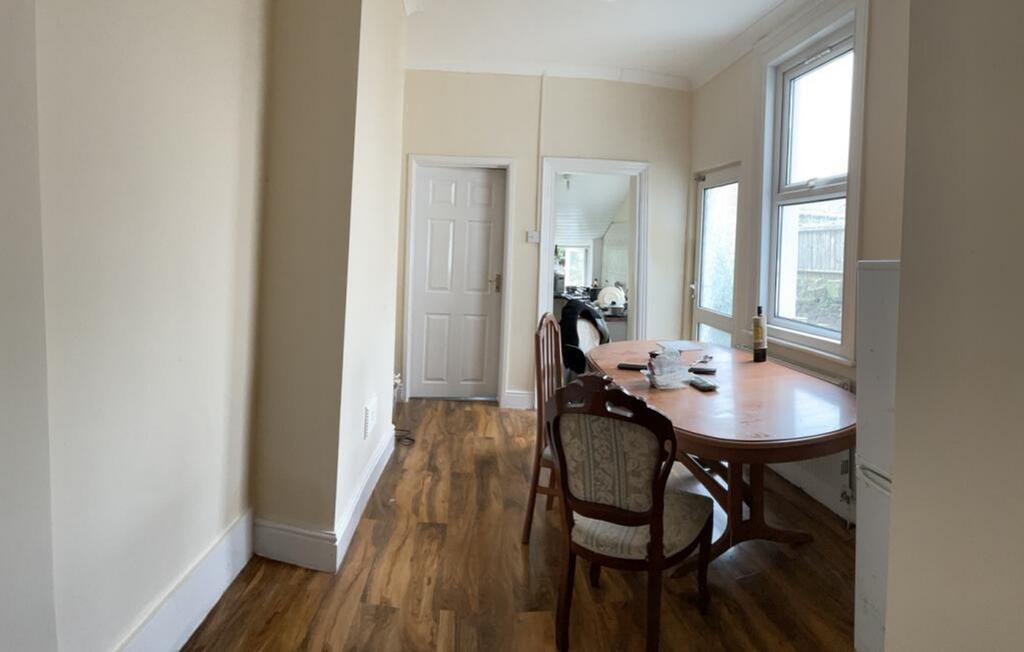 A well-lit kitchen with a spacious dining area,...