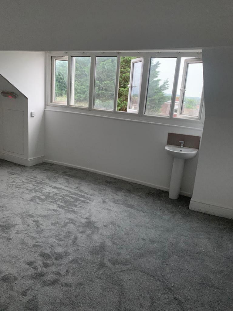 This inviting double bedroom features large win...