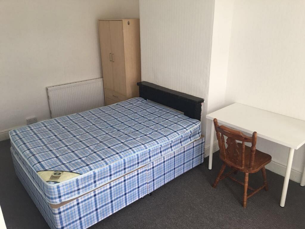 This inviting double bedroom features a comfort...
