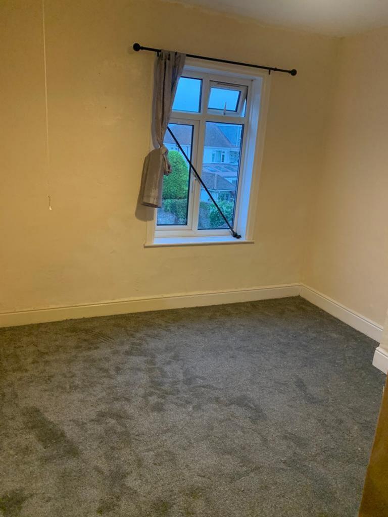 A cozy double bedroom featuring soft carpeting ...