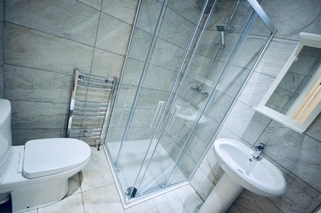 A modern bathroom featuring a sleek shower and ...