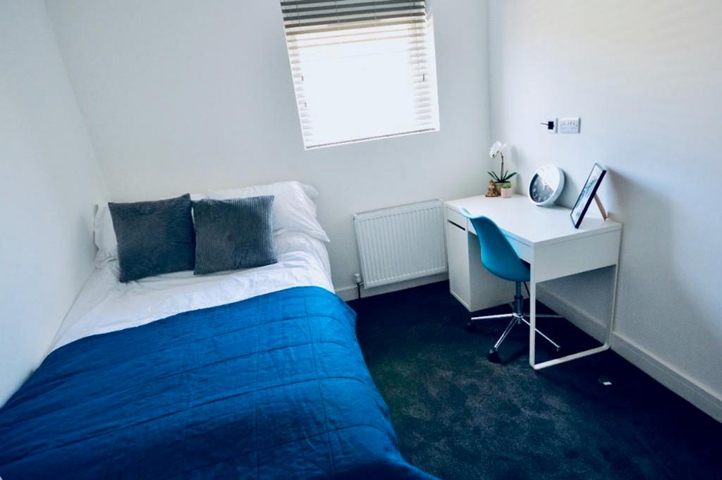 A bright and inviting double bedroom featuring ...