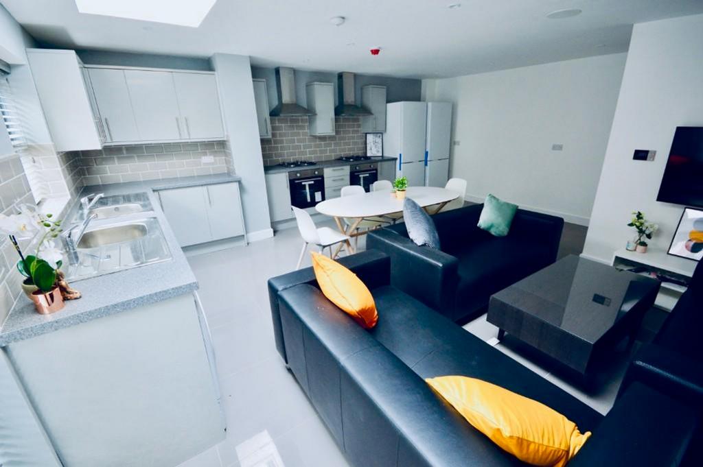 A spacious and stylish living room featuring mo...