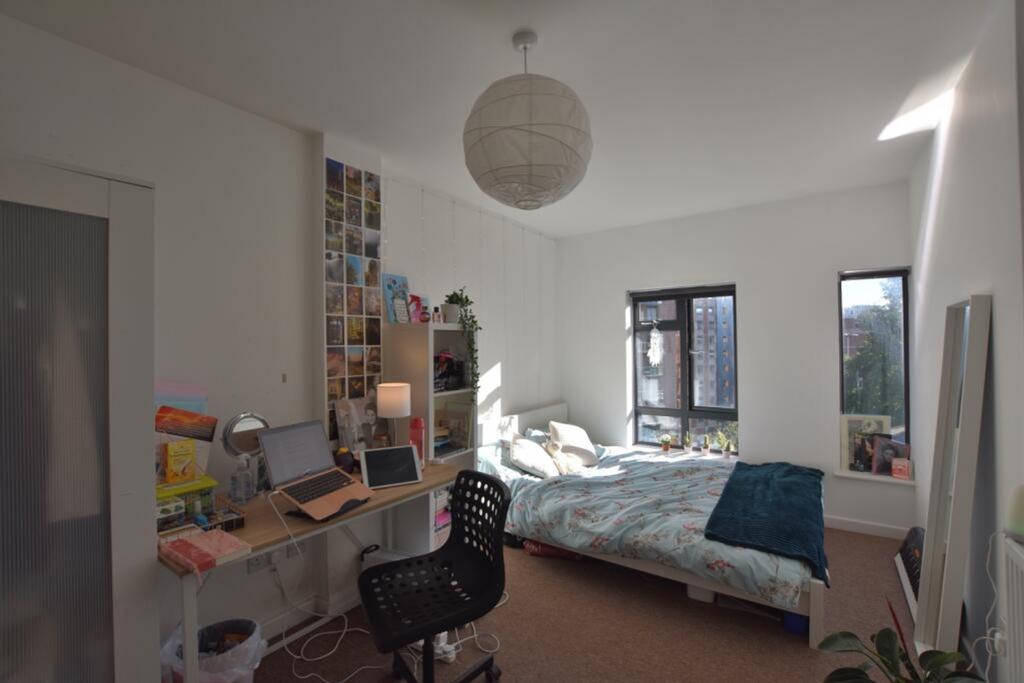 A bright and inviting double bedroom featuring ...