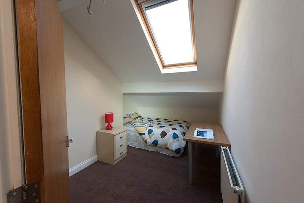 This charming double bedroom features a cozy la...