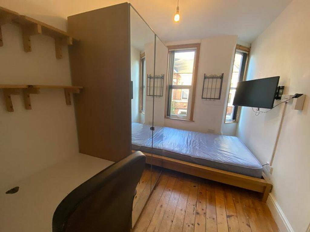 A bright and tidy double bedroom with ample nat...