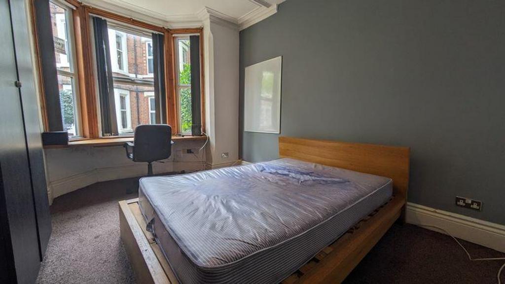 A bright and spacious double bedroom with large...