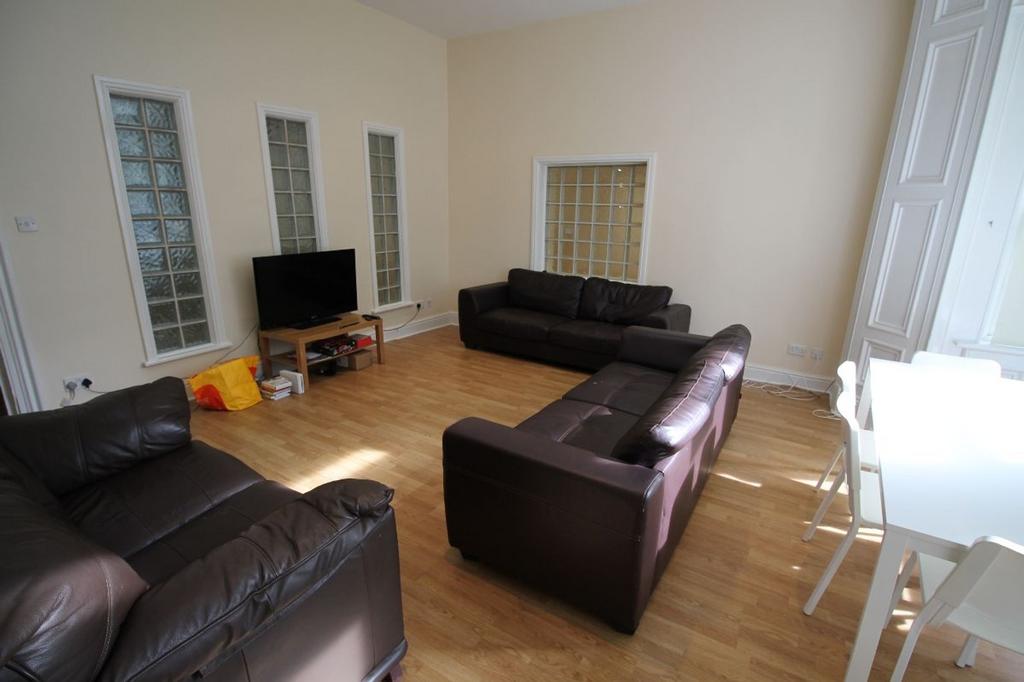 Bright and spacious living room featuring comfo...