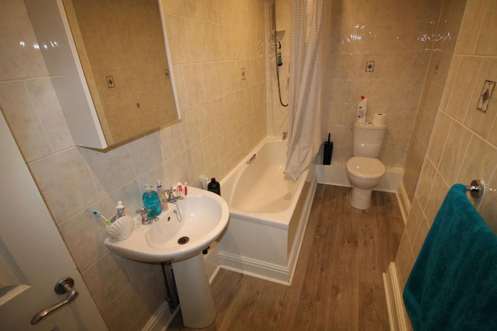 A well-maintained bathroom featuring a modern b...