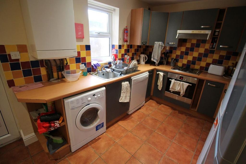 This charming kitchen features vibrant tiled wa...
